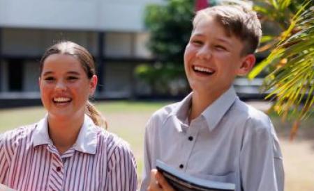 Two students smiling